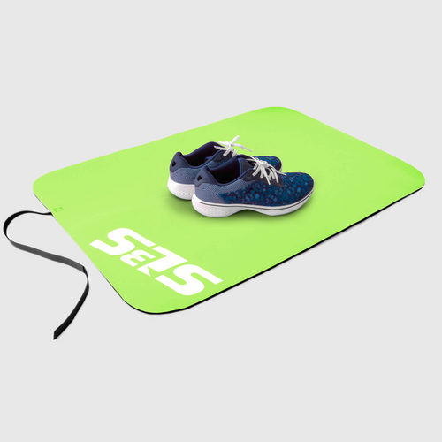 A pair of shoes on a green transition mat