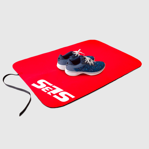 A pair of shoes on a red transition mat