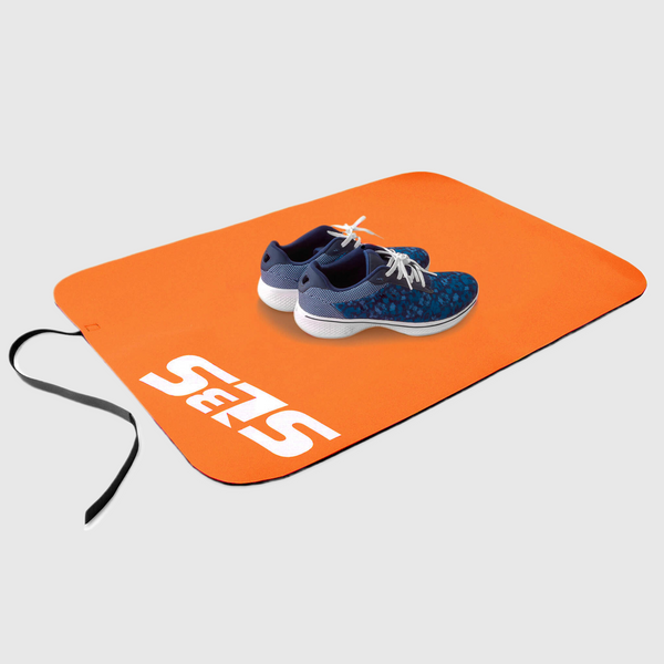 A pair of shoes on an orange transition mat