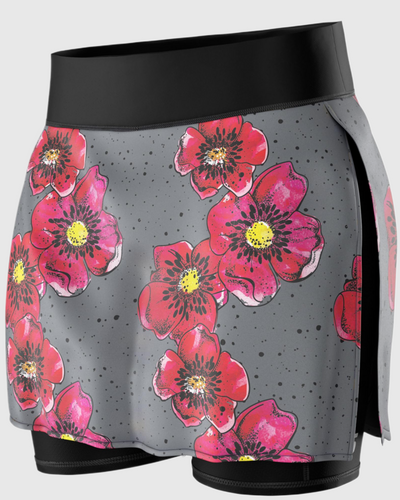 A close-up of a gray running skirt with red flower prints on it