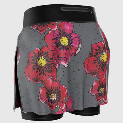 A back view of a gray running skirt with red flower prints on it