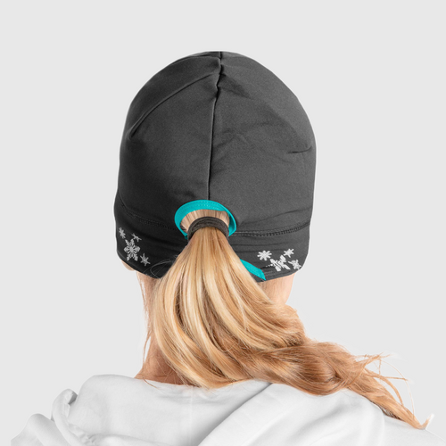 Back view of a woman wearing a black ponytail beanie with teal accent