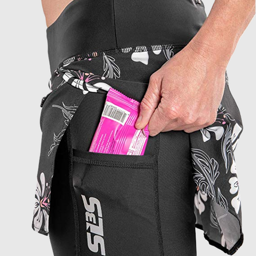 A person's hand putting a packet in a pocket