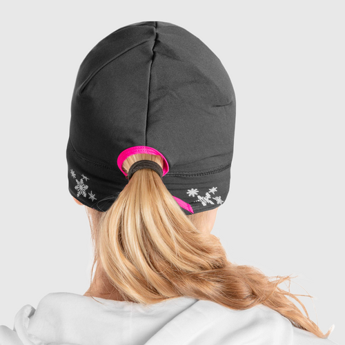 Back view of a woman wearing a black ponytail beanie with pink accent