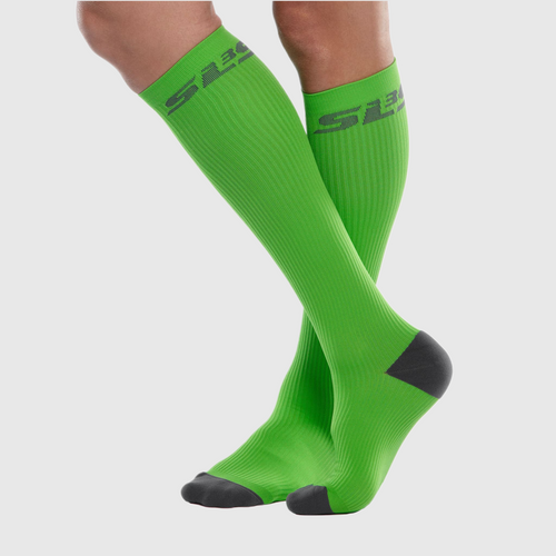 Close-up of a person's leg wearing green compression socks