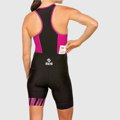 A woman wearing a tri suit taking out a packet from the back pocket