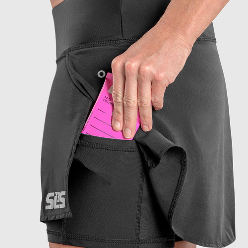 A person putting a pink packet in their side pocket