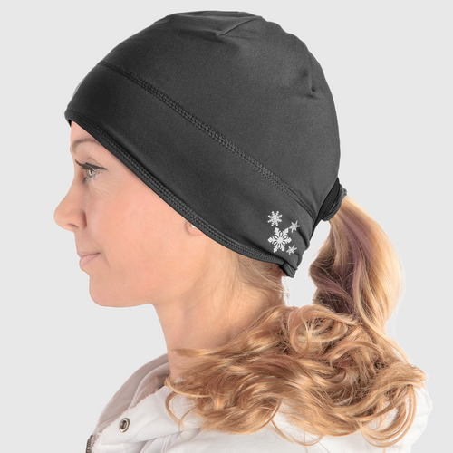 Profile view of a woman wearing a black ponytail beanie with snowflake design