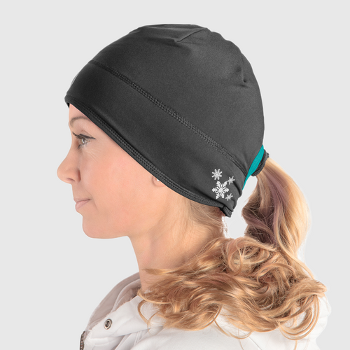 Profile view of a woman wearing a black ponytail beanie with teal accent