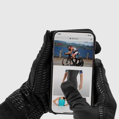 A person wearing black running gloves holding a phone