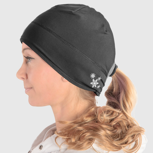 Profile view of a woman wearing a black ponytail beanie