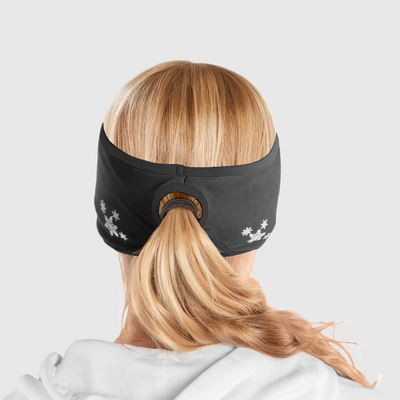 A back view of a woman wearing an all black ponytail headband