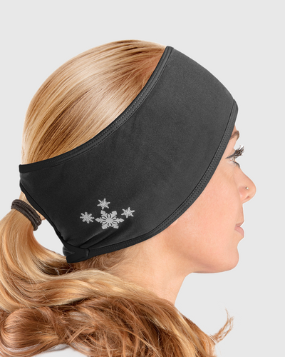 A side view of a woman wearing an all black ponytail headband with snowflake design