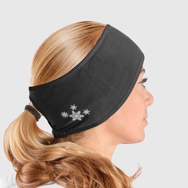 A side view of a woman wearing an all black ponytail headband with snowflake design