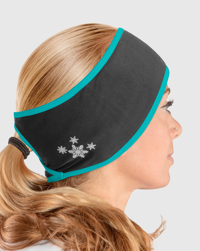 A side view of a woman wearing a black and blue ponytail headband with snowflake design