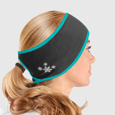 A side view of a woman wearing a black and blue ponytail headband with snowflake design