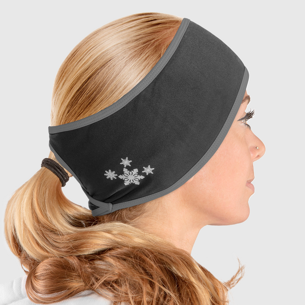 A side view of a woman wearing a black and gray ponytail headband with snowflake design