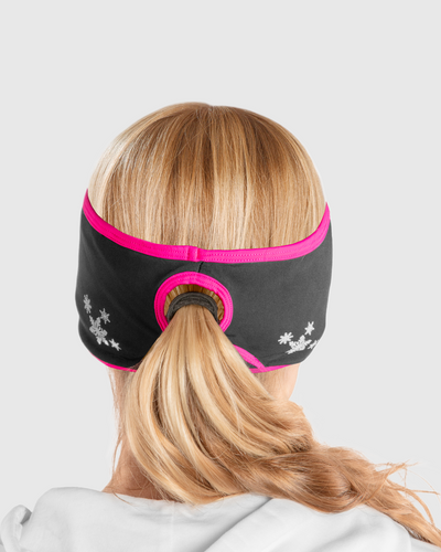 A back view of a woman wearing a black and pink ponytail headband