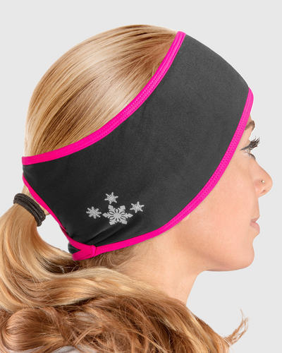 A side view of a woman wearing a black and pink ponytail headband with snowflake design