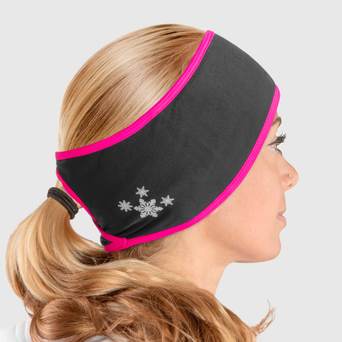 A side view of a woman wearing a black and pink ponytail headband with snowflake design