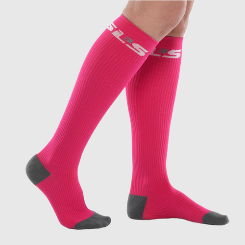 A person wearing bright pink compression socks