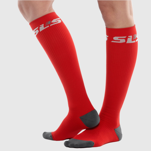 A person wearing vibrant red compression socks
