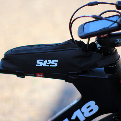 Close-up of a black bike frame displaying a mounted top tube bag