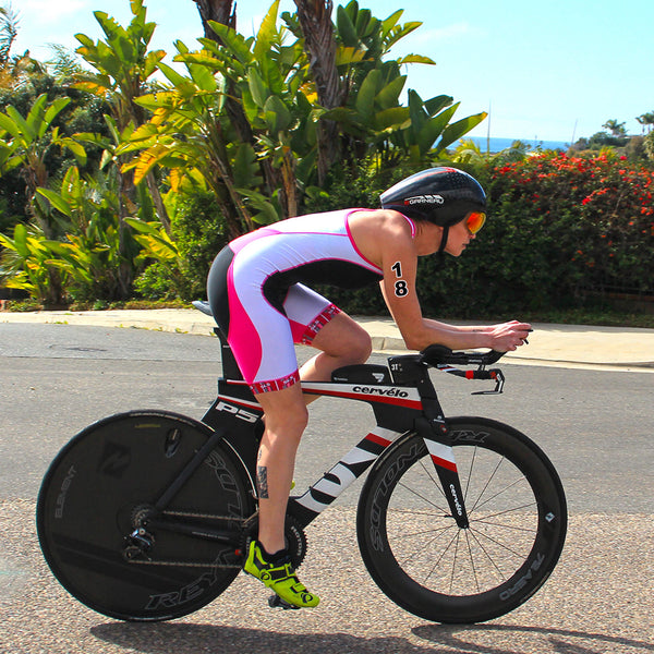 A person riding a bike with number tattoos in hand