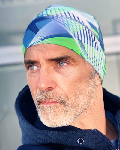 runners beanieClose-up of a man wearing a green and blue patterned running beanie