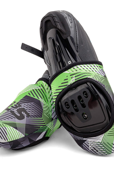 A pair of green and black cycling toe covers with geometric patterns