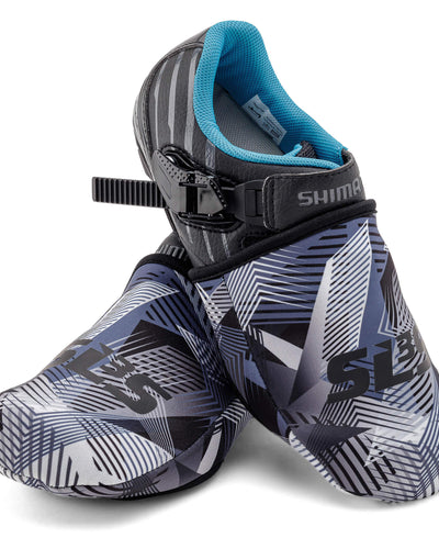 A pair of cycling toe covers with a blue, black, and white geometric pattern