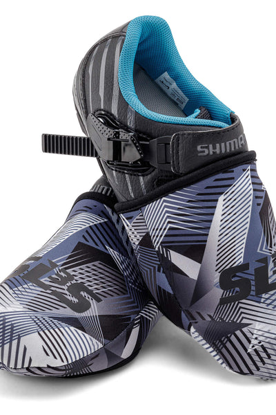 A pair of cycling toe covers with a blue, black, and white geometric pattern