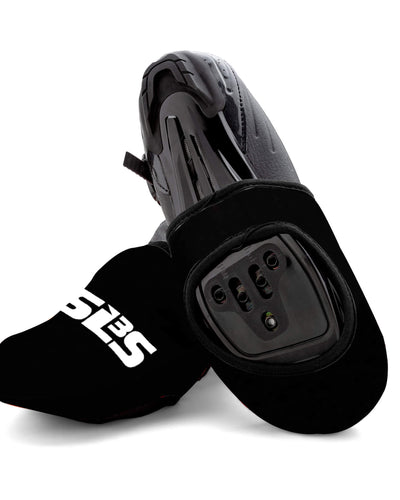 A pair of black cycling toe covers with cycling shoes