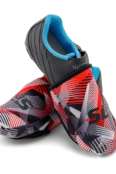  A pair of colorful cycling toe covers with a black, red, and white geometric design