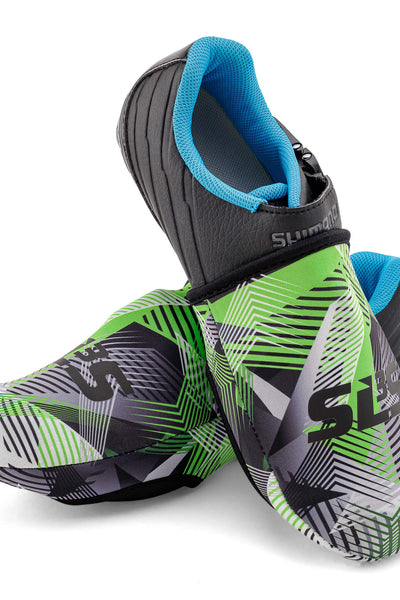 A pair of cycling toe covers with a black and green geometric design